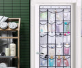 28-pocket mesh over-door organizer on bathroom door loaded with toiletry bottles in green-tiled bathroom