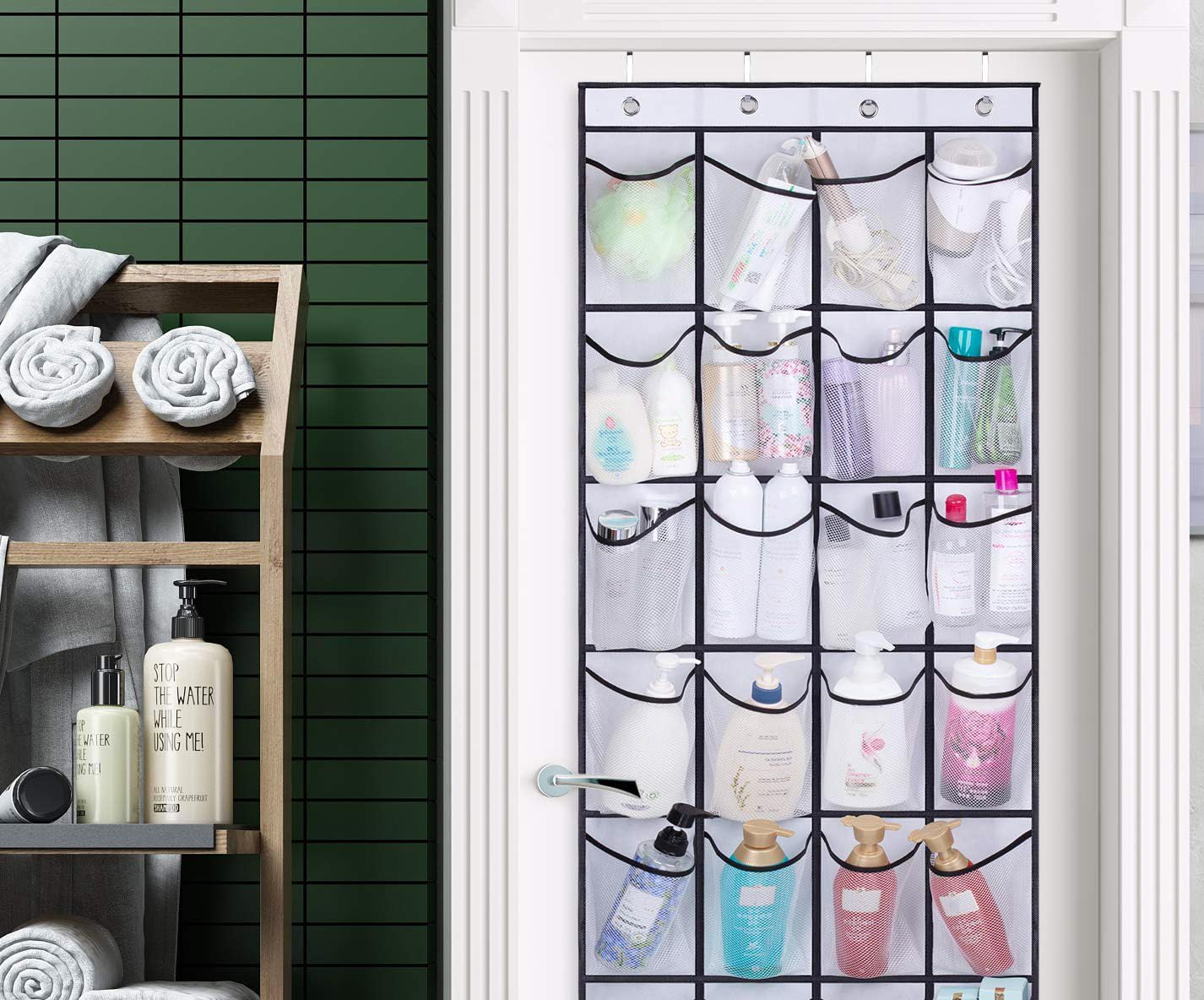 28-pocket mesh over-door organizer on bathroom door loaded with toiletry bottles in green-tiled bathroom