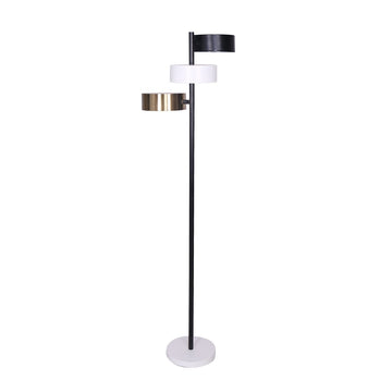 Three-arm floor lamp with black, white, and brass drum shades on black pole with white round base, white background