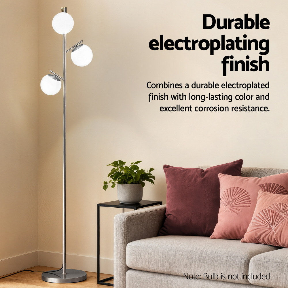 Feature banner Durable electroplating finish with 3-globe silver floor lamp beside a sofa with pink cushions and plant
