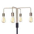 Close-up of four curved gold arms with amber Edison filament bulbs converging at a black central hub on black pole