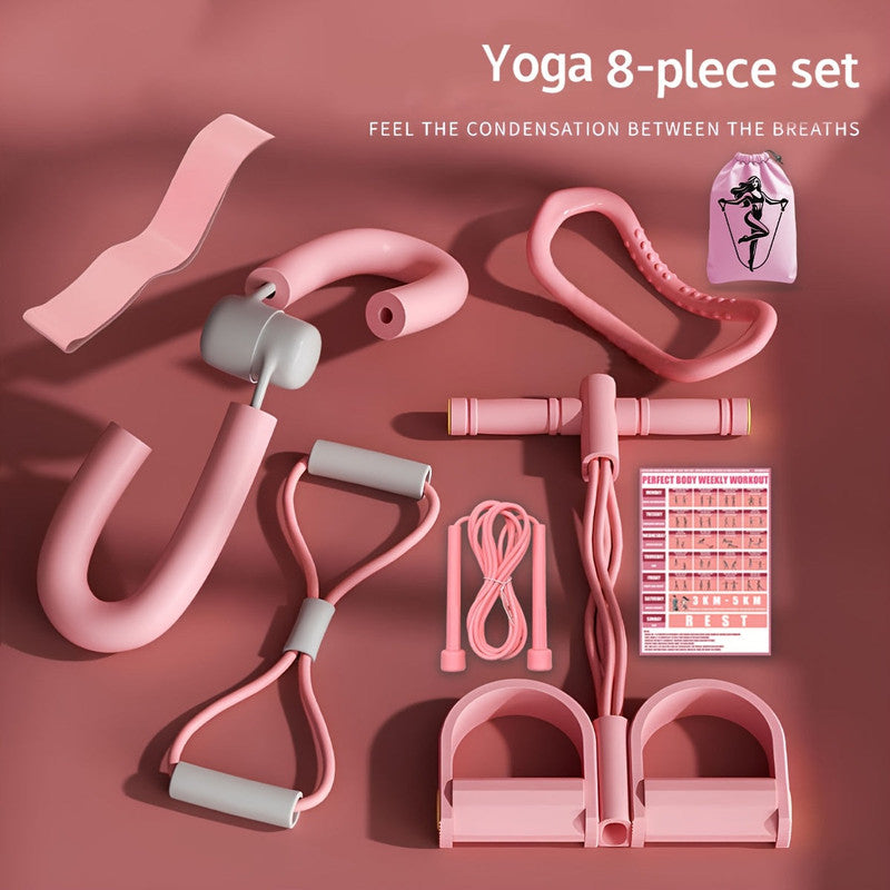 pink 8-piece yoga fitness kit flat lay on rose background with workout planner card and carry bag