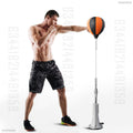 Man punching orange and black speed bag on adjustable silver stand with spring and weighted base