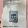 Printed counter instruction card showing START/STOP and RESET button steps with photo of digital timer display