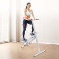 Woman stepping on white stair stepper in home room, holding handlebar, red motion spiral graphics at waist and knee