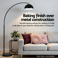 Feature banner Baking finish over metal construction with arc lamp and black dome shade over a grey sofa with cushions