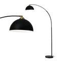 Black arc floor lamp with matte dome shade, brass joint fitting, and round marble base on white background