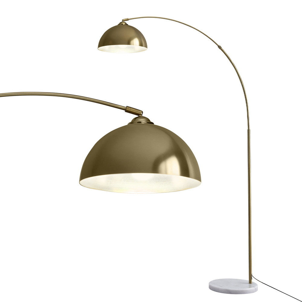 Arc floor lamp with large gold dome shade and white marble base, with detail view of shade interior from below
