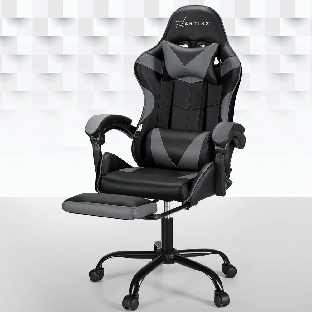 Artiss black and grey massage gaming chair with footrest extended in room with geometric wall panels