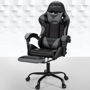 Artiss black and grey massage gaming chair with footrest extended in room with geometric wall panels