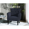 Artiss black linen button-tufted armchair with turned wooden legs in dark styled room with plant, marble side table, and rug