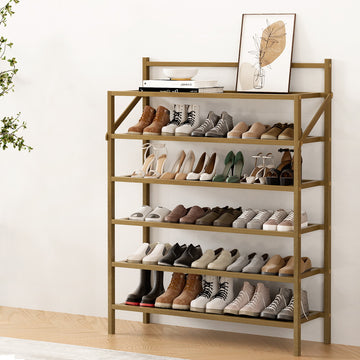 Natural bamboo 6-tier shoe rack loaded with boots, heels and sneakers against wall in room setting
