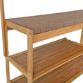 Close-up of bamboo bench seat with taupe woven fabric cushion above two open bamboo shoe shelves
