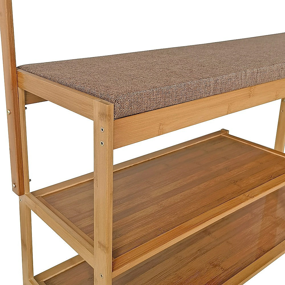 Close-up of bamboo bench seat with taupe woven fabric cushion above two open bamboo shoe shelves