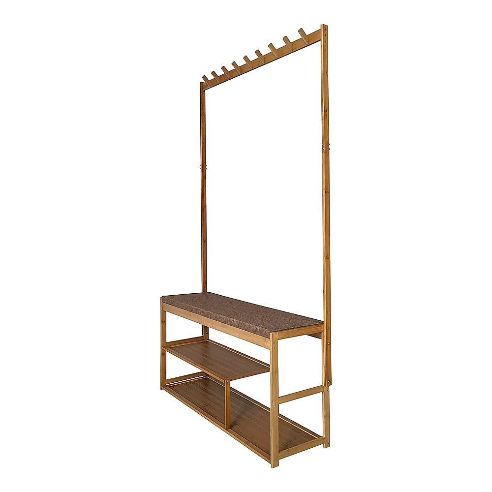 Bamboo hall coat rack with diagonal hooks on upright, padded fabric bench seat and two lower shoe shelves, angle view