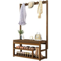 Bamboo coat rack front view styled with coats and hat on hooks, shoes on two lower shelves, bag and plant on bench