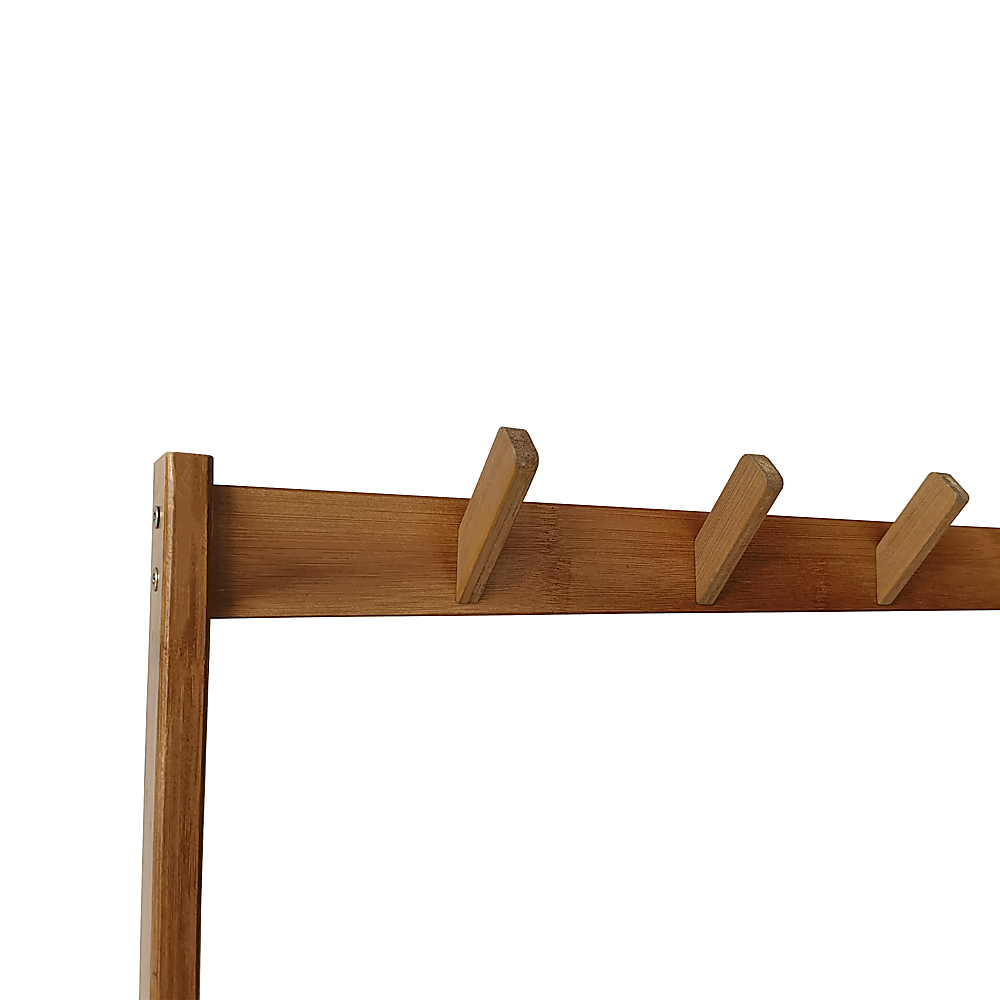 Close-up of bamboo coat rack top rail showing three angled rectangular bamboo coat hooks on white background
