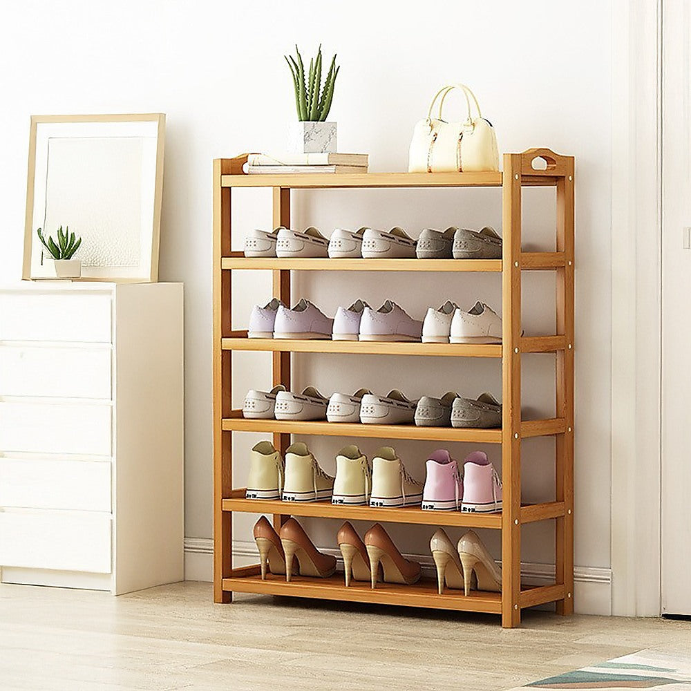 Natural bamboo 6-tier shoe rack fully loaded with shoes, bag and plant on top shelf, in room setting