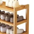 Natural bamboo shoe rack with side handle cutouts loaded with heels and flats, handbag on top shelf