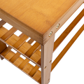 Close-up of bamboo shoe bench corner joint showing brass screws and black anti-slip rubber foot