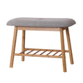 Bamboo shoe bench with grey button-tufted cushion, three-quarter angle view on white background