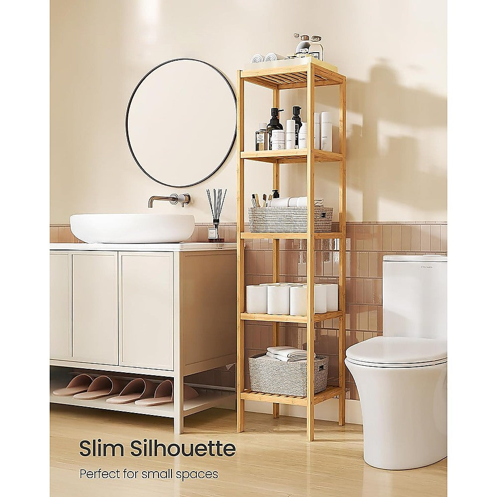 Bamboo slim shelf in bathroom between vanity and toilet, styled with skincare, towels and baskets; text reads Slim Silhouette