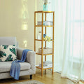 Bamboo slim shelving unit in bright living room with books, roses and wicker basket beside grey sofa and white curtains