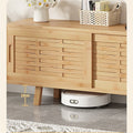 Natural bamboo TV unit lower close-up 13cm leg height with robot vacuum underneath daisy flowers and basket on top