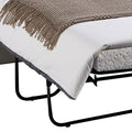 Close-up of beige sofa bed pull-out frame showing black metal folding base, white mattress and brown throw blanket