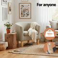 Beige fabric tub armchair in living room with throw blanket showing 130kg capacity and anti-slip floor protectors badges