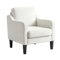 Beige linen armchair with piped trim, box back cushion and dark tapered legs, angle view on white background