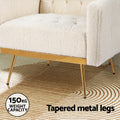Close-up of cream teddy armchair gold tapered metal legs and base rail showing 150kg weight capacity badge on circular rug