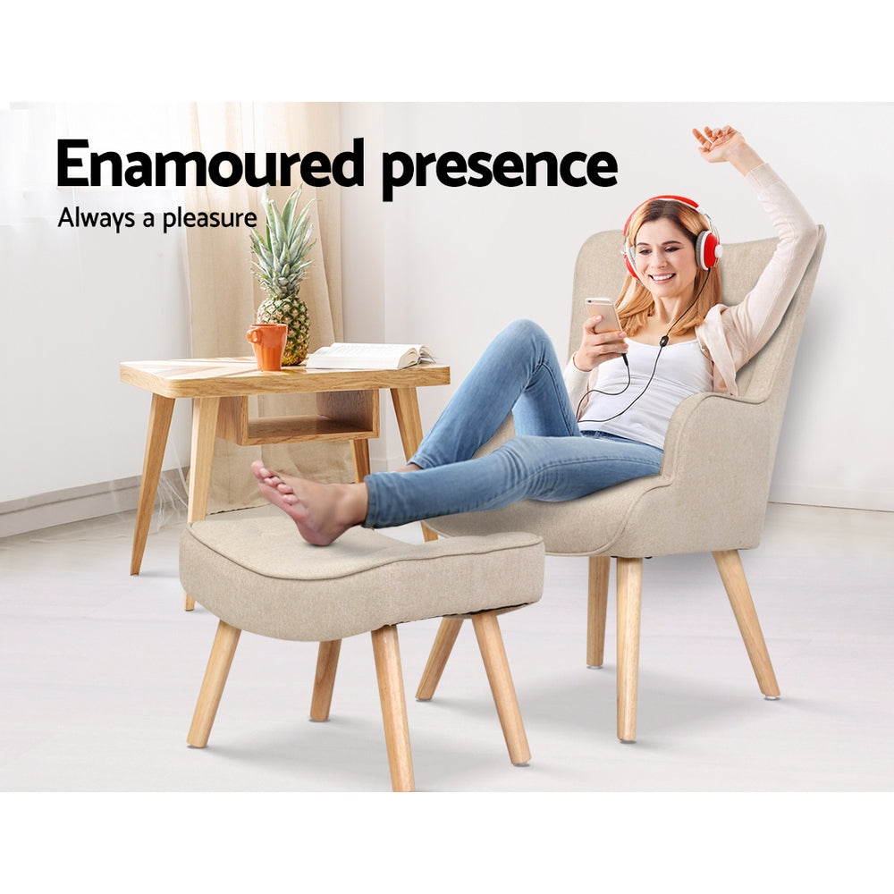 Beige fabric wingback armchair and footstool in use with person seated feet on ottoman and Enamoured presence text
