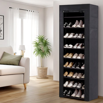Black fabric-covered 10-tier shoe rack in living room with front cover open showing shoes on shelves