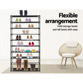Black 10-tier shoe rack with heels coloured flats and tall boots flexible arrangement text round wicker chair beside