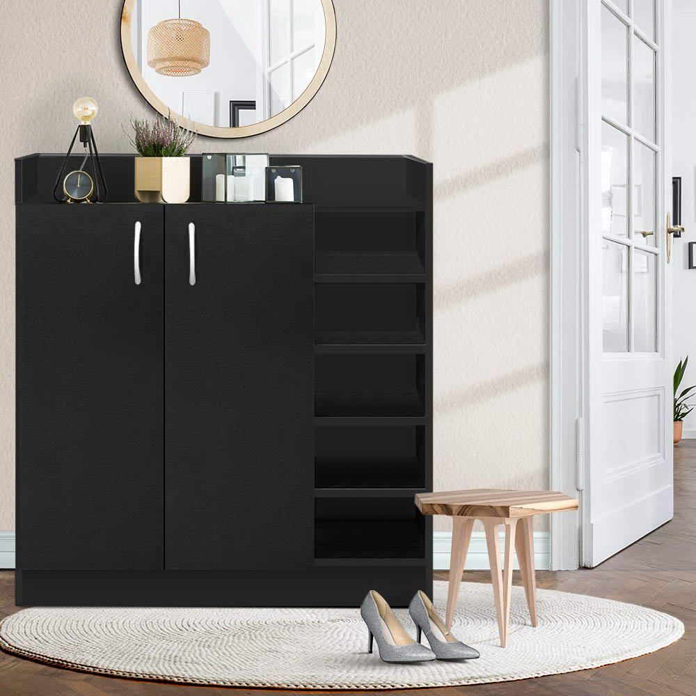 Black shoe cabinet with 2 doors and 5 open side shelves in hallway, white C-handles, decor on top