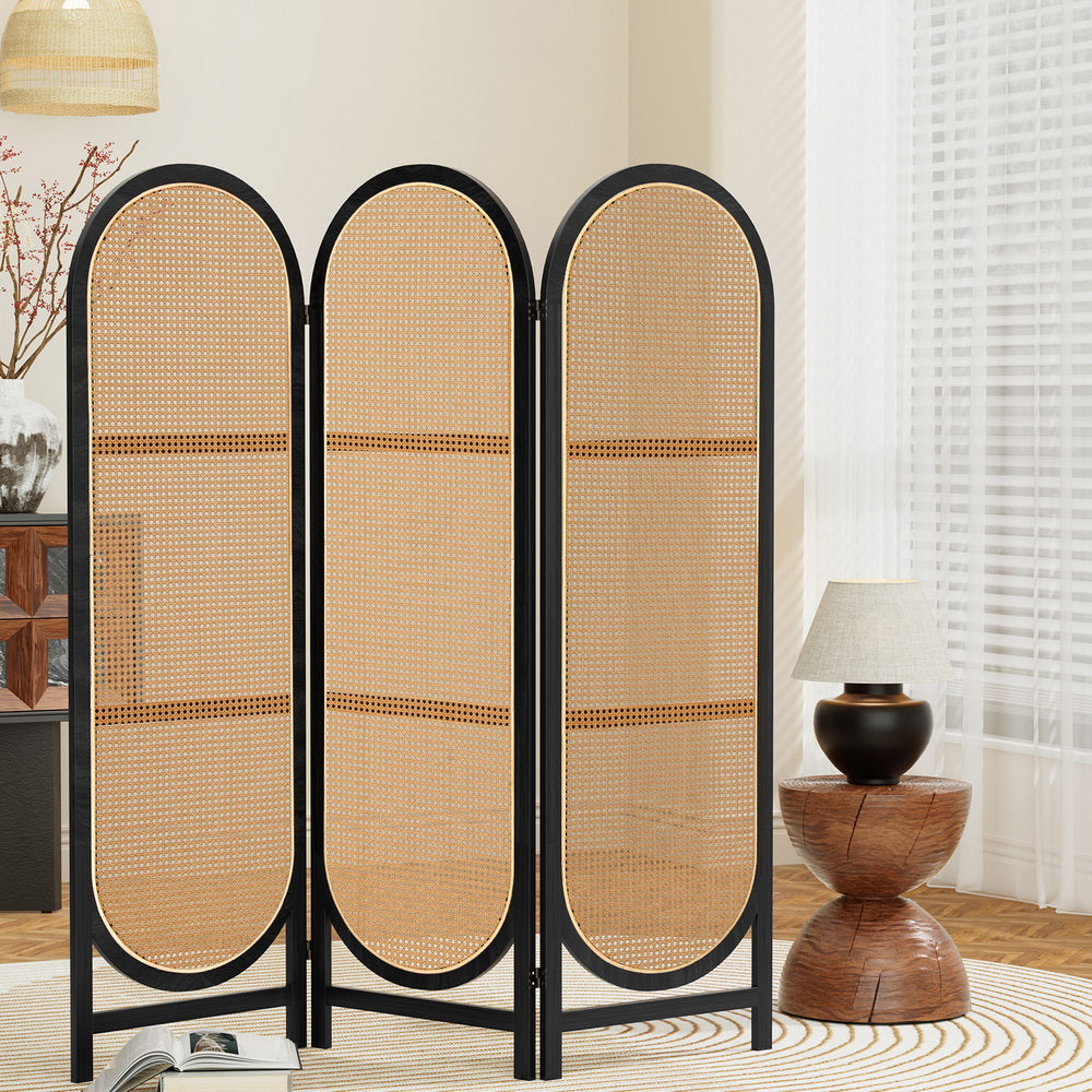 Black 3-panel arched rattan room divider in living room lifestyle with wooden round sideboard and rattan pendant lamp