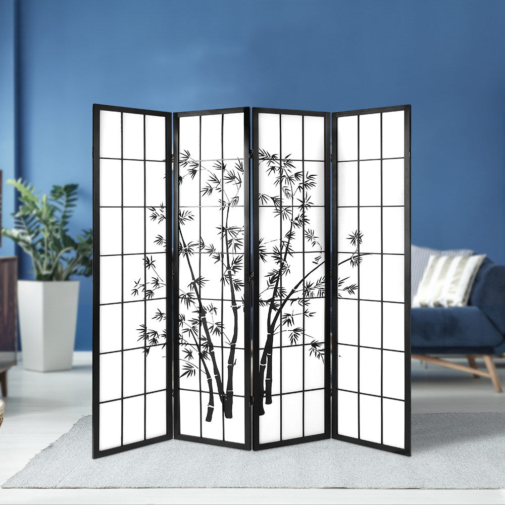 Black 4-panel bamboo print shoji room divider in lifestyle room against blue wall with ZZ plant and blue sofa and cream rug