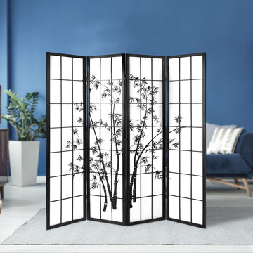 Black 4-panel bamboo print shoji room divider in lifestyle room against blue wall with ZZ plant and blue sofa and cream rug