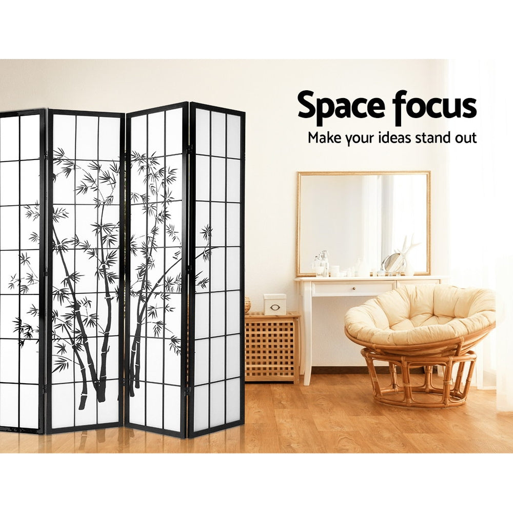 Black 4-panel bamboo print shoji room divider in bedroom lifestyle with papasan rattan chair and white dressing table mirror