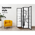 Black 4-panel bamboo print shoji room divider in living room lifestyle with yellow armchair and ZZ plant against white wall