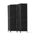 Black 4-panel woven paper rope room divider angled zigzag view on white background with black metal tube frame and feet