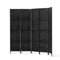 Black 4-panel woven paper rope room divider curved arc configuration on white background with black metal tube feet