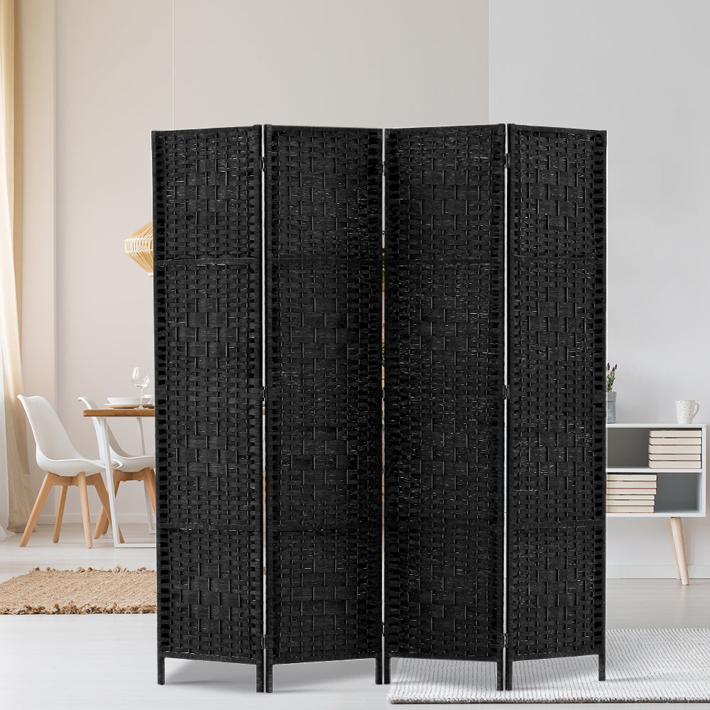 Black 4-panel woven paper rope room divider in lifestyle room with white chair dining table books and grey sideboard