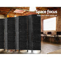 Black 4-panel woven paper rope room divider in industrial office lifestyle with exposed ceiling beams and computer desks