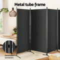 Black 4-panel fabric room divider metal tube frame in bedroom lifestyle with detachable connectors close-up