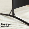 Black 4-panel fabric room divider round foot pedestal close-up on cream rug with black X-base triangular brace arms