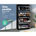 Black four-tier shoe cabinet all flip-out trays open loaded with shoes shoe paradise up to 60 pairs badge shown in lifestyle