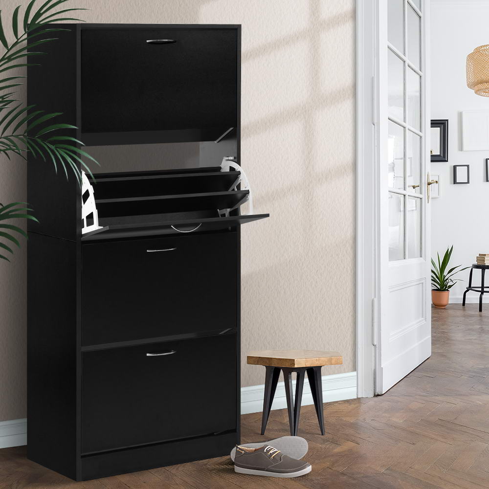 Black four-tier flip-out shoe cabinet second compartment tray open in hallway lifestyle with wooden stool and palm plant