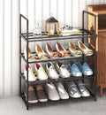 Black 4-tier metal tube shoe rack 55cm in hallway with colorful flats and loafers, lantern and decor on top